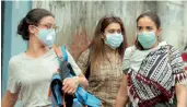  ?? — BIPLAB BANERJEE ?? Tourists wear anti-pollution masks in New Delhi on Sunday.