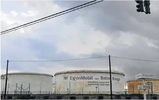  ?? /Reuters ?? Incentive: Storage tanks inside the Exxon Mobil Baton Rouge Refinery in Louisiana, US. The government of Guyana says it will honour the terms of its deal with Exxon.