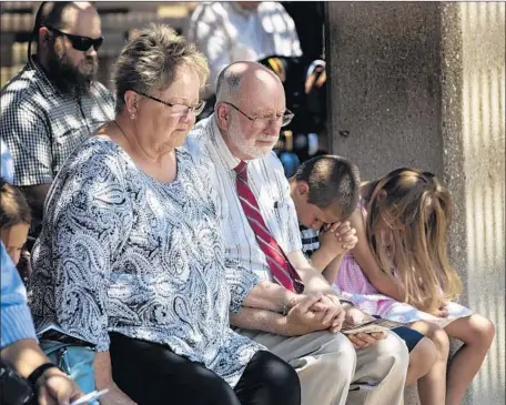  ?? Gina Ferazzi Los Angeles Times ?? PHILLIP ROSENKRANT­Z, center, with wife Judy and other relatives, attends the funeral for his uncle, who was 28 when he was killed.