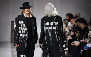  ?? — AFP photo ?? Reedus (left) presents a creation by Yohji Yamamoto for the Menswear Readyto-wear Fall-Winter 2024/2025 collection as part of the Paris Fashion Week, in Paris.