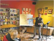  ?? ROBERT NOTT/THE NEW MEXICAN ?? City of Santa Fe councilor Michael Harris points to a map of the Santa Fe University of Art and Design during a presentati­on he gave on the future of the campus for Journey Santa Fe at the Collected Works Bookstore and Coffeeshop on Sunday morning.