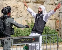  ??  ?? Gaza: A rocket is launched Face off: Protester and policeman in the Old City