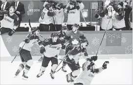  ?? CANADIAN PRESS FILE PHOTO ?? Mat Robinson reacts as Germany players celebrate after defeating Canada to advance to the gold medal game at the Olympic Winter Games in Gangneung, South Korea, a year ago.