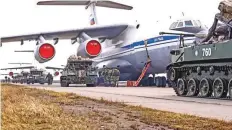  ?? AP ?? Russian military vehicles prepare for being loaded into a plane for airborne drills during manoeuvres in Crimea.