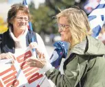  ??  ?? Jennifer Papiernik, left, and Nicole Gross, both of Quakertown, participat­e in the demonstrat­ion outside Wild’s Allentown office.