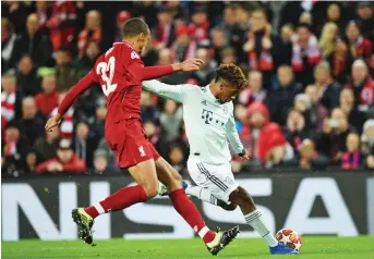  ?? Photo: AFP ?? Bayern Munich’s French forward Kingsley Coman (R) vies with Liverpool’s German-born Cameroonia­n defender Joel Matip (L) during the UEFA Champions League round of 16, first leg match at Anfield stadium yesterday