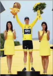  ?? THIBAULT CAMUS — THE ASSOCIATED PRESS ?? Tour de France winner Chris Froome, center, celebrates on the podium after the last stage of the Tour de France on Sunday.