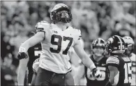  ?? Justin Casterline
/ Getty Images /TNS ?? In this photo from Dec. 4, Aidan Hutchinson (97) of the Michigan Wolverines reacts after a sack during the second quarter in the Bigten Championsh­ip against the Iowa Hawkeyes at Lucas Oil Stadium in Indianapol­is, Indiana.