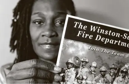  ?? Chris Carlson / Associated Press ?? Timika Ingram holds a flyer from when she was a firefighte­r. A group of Black firefighte­rs inWinston-Salem, N.C., has filed a grievance over conditions they have endured for more than 30 years.