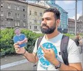  ?? [PHOTO PROVIDED] ?? Missions leader Isaac Valdez holds up “Flat Walker,” an image of Awe Star Missions founder Walker Moore, during a mission trip to Budapest, Hungary.