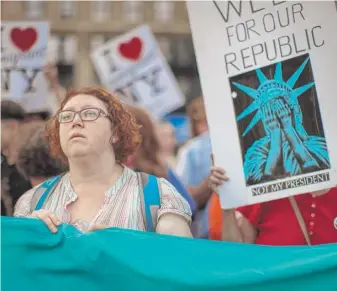  ?? ANDRES KUDACKI/ AP ?? People attend a rally in New York about the U. S. Supreme Court’s decision to uphold President Donald Trump’s ban on travel from several mostly Muslim countries Tuesday.