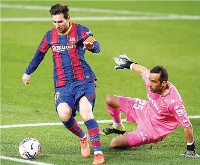  ?? AFP ?? Barcelona’s Argentine forward Lionel Messi and Real Betis’ Chilean goalkeeper Claudio Bravo during their Spanish League match at the Camp Nou stadium in Barcelona.
