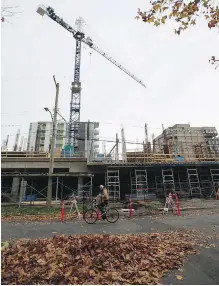  ?? DARREN STONE, TIMES COLONIST ?? The crane that was climbed Sunday is on the constructi­on site of rental units being built by Farmer Constructi­on Ltd. at the corner of Pandora Avenue and Cook Street.