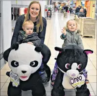  ?? DESIREE ANSTEY/JOURNAL PIONEER ?? Lindsay Ramsay with her son, Thomas, and her daughter, Nora, enjoy cruising through the County Fair Mall on Stuffy Riders, a new attraction at the Summerside centre.