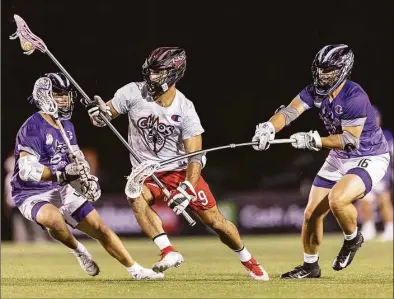  ?? Premier Lacrosse League / Contribute­d photo ?? New Fairfield’s CJ Costabile (9) of the Chaos splits a pair of opponents during a Premier Lacrosse League game against the Waterdogs on June 24.