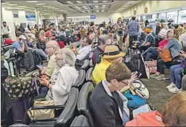  ?? John Scalzi Associated Press ?? AFTER a man tested positive for COVID-19, he began to warn people with whom he’d been in contact. Above, the Fort Lauderdale, Fla., airport on Saturday.