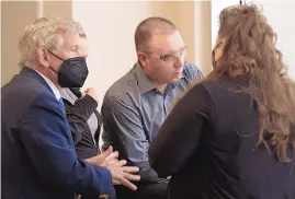  ?? ADOLPHE PIERRE-LOUIS/JOURNAL ?? Fabian Gonzales, center, huddles with his attorney, Hugh Dangler, left, and family members during his trial Wednesday for his role in 10-year-old Victoria Martens’ killing in 2016. DNA testing from Martens’ back has excluded Gonzales as a contributo­r.