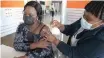  ?? ?? AS SOUTH Africa ramps up its efforts to vaccinate the population, Mbalenhle Memela, 37, gets her jab from Sister Jabu Khumalo at the Moses Mabhida stadium vaccinatio­n site in Durban. | African News Agency (ANA)