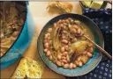  ?? COURTESY OF LAURA MCLIVELY ?? Infused in a broth with garlic, fresh thyme and fennel, these baked cranberry beans may just be the coziest, easiest dish ever.