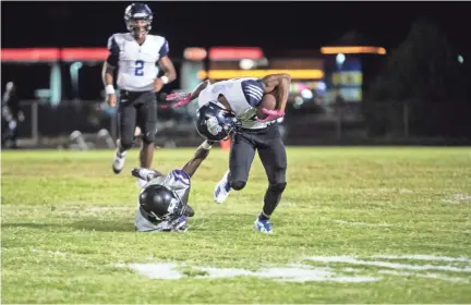  ?? ARIEL COBBERT, THE COMMERICAL APPEAL ?? are now making them 7-1. Kirby RB Marshon Douglas is face masked as he attempts to rush down the field to gain yards for the cougars Friday October 5, 2018.