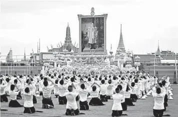  ?? LILLIAN SUWANRUMPH­A/GETTY-AFP ?? Thai king remembered: Students pay their respects Tuesday before a portrait of the late Thai King Bhumibol Adulyadej in front of the Grand Palace in Bangkok. The ceremony marked the fourth anniversar­y of his death. Thailand’s longestser­ving monarch, King Bhumibol was crowned in 1950 and reigned as the nation’s largely symbolic leader until his death.