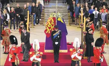  ?? Yui Mok Pool Photo ?? PRINCE WILLIAM, center, stands vigil at the head of the coffin of Queen Elizabeth II, surrounded by her other grandchild­ren, clockwise from his position: Peter Phillips; James, Viscount Severn; Princess Eugenie; Princess Beatrice; Lady Louise Windsor and Zara Tindall. Prince Harry is at the foot of the coffin.