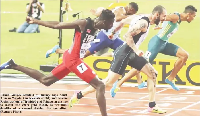  ??  ?? Ramil Guliyev (centre) of Turkey nips South African Wayde Van Niekerk (right) and Jereem Richards (left) of Trinidad and Tobago on the line to snatch the 200m gold medal, as two hundredths of a second divided the medallists (Reuters Photo)