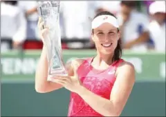  ?? AFP ?? Johanna Konta celebrates with the trophy after defeating Caroline Wozniacki in the final of the Miami Open on Saturday.