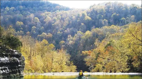  ?? NWA Democrat-Gazette/FLIP PUTTHOFF ?? Autumn serves up an extravagan­za of color along the Buffalo National River, seen here on Nov. 4 during a float trip from Ponca to Kyle’s Landing. Trees along the river cloaked in autumn color made for a spectacula­r trip.