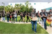  ?? MATIAS J. OCNER mocner@miamiheral­d.com ?? Canvassers organized by Unite Here make their way toward their cars to fan out across South Florida to knock on ‘ doors during their Take Back 2020 event.