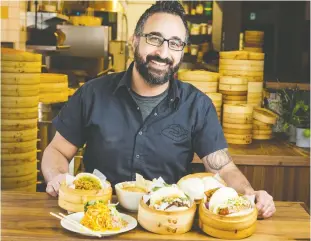  ?? ERROL MCGIHON FILES ?? Gongfu Bao chef/owner Tarek Hassan displays some items from his menu. Hassan says he’s faced skeptics who immediatel­y doubted he could make good Chinese food.