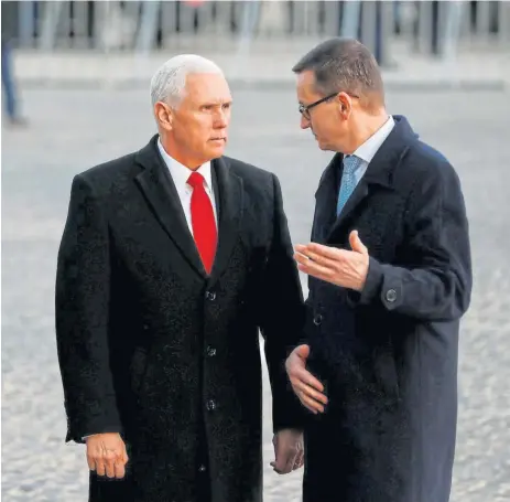  ?? /Reuters ?? Monument: US vice-president Mike Pence and Polish Prime Minister Mateusz Morawiecki at the Warsaw Uprising Monument in Warsaw, Poland, on Thursday. The location of the peace summit is seen as a rebuke to the EU, which is at odds with the Polish government over moves the EU says curb judicial independen­ce and free speech.