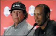  ?? MATT SLOCUM — THE ASSOCIATED PRESS FILE ?? In this file photo, Phil Mickelson, left, listens to Tiger Woods speak during a news conference where they were announced as captain’s picks for the 2018 U.S. Ryder Cup Team, in West Conshohock­en, Pa. Woods and Mickelson have combined for 124 wins on the PGA Tour, and Mickelson believes they’re not done.