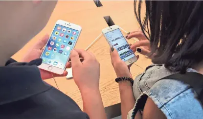  ?? MARK SCHIEFELBE­IN/AP ?? Customers try out Apple iPhone 6s models on display at an Apple Store in Beijing. New documents from WikiLeaks point to an apparent CIA program to hack Apple devices, but there’s no evidence the program persisted past the iPhone 3G model, released in...