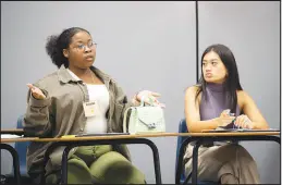  ?? ?? Beautiful Wiley, left, of Del Sol High School, and Jazmyn Espinueva of College of Southern Nevada High School discuss a question on marijuana during the Sun Youth Forum.