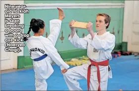  ?? ?? Nine-yearold Tazkiah Meyers is seen breaking a board with a drop axe kick (Naeryeo Chagi).