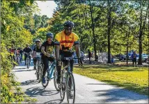  ?? CONTRIBUTE­D BY EBENEZER BAPTIST CHURCH ?? The Rev. Raphael Warnock, senior pastor of Ebenezer Baptist Church in Atlanta, rides along with others in the “Faith & Fitness” ministry.