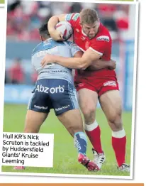  ??  ?? Hull KR’s Nick Scruton is tackled by Huddersfie­ld Giants’ Kruise Leeming