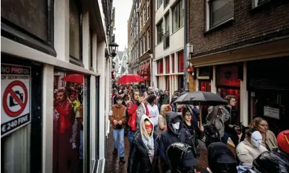  ?? Photograph: Hollandse Hoogte/Shuttersto­ck ?? Protesters march through the red light district of Amsterdam.