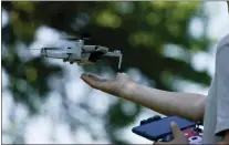  ?? NATACHA PISARENKO — THE ASSOCIATED PRESS ?? Andriy Pokrasa, 15, lands his drone on his hand during an interview with The Associated Press in Kyiv, Ukraine, Saturday, June 11, 2022. Andriy is being hailed in Ukraine for stealthy aerial reconnaiss­ance work he has done with his dad in the ongoing war with Russia. They used their drone to help the country’s military spot, locate and destroy Russian targets in the early days of the Russian invasion.