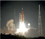  ?? AP ?? Nasa’s new moon rocket lifts off from Launch Pad 39B at the Kennedy Space Centre in Cape Canaveral, Florida, yesterday.