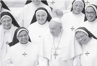  ?? AP PHOTO/ANDREW MEDICHINI ?? POPE Francis poses for a photo with a group of nuns at the end of his weekly general audience in the Pope Paul VI hall at the Vatican on Wednesday, January 4, 2023.
