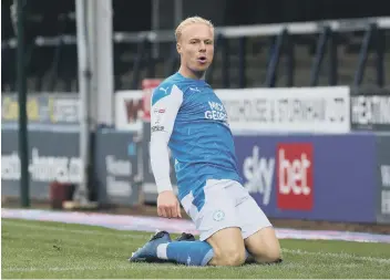  ??  ?? Ryan Broom after scoring for Posh.