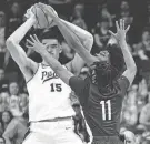  ?? ADAM CAIRNS/COLUMBUS DISPATCH ?? Purdue center Zach Edey tries to pass over Fairleigh Dickinson’s Sean Moore, a Reynoldsbu­rg High grad.