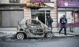  ?? Picture: AFP ?? MORE SERIOUS. Police look at a burnt-out car in Paris yesterday – a day after a fourth weekend of nationwide protests.