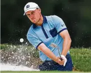  ?? Tom Pennington / Getty Images ?? Jordan Spieth plays a shot from a bunker on No. 7 in the first round of the Charles Schwab Challenge at Fort Worth. He is one shot back after an opening 65.