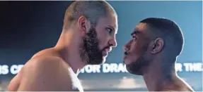  ?? BARRY WETCHER ?? Viktor Drago (Florian Munteanu) towers over Adonis Creed (Michael B. Jordan) in the next-gen chapter of a family fight begun in “Rocky IV.”