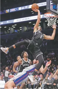  ?? FRANK FRANKLIN II/ASSOCIATED PRESS ?? The Nets’ Spencer Dinwiddie drives over the Pistons’ Blake Griffin on Wednesday in New York. The Nets won 120-119.