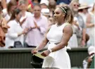  ?? AP Photo/Tim Ireland ?? ■ Serena Williams holds the runner-up trophy after losing to Romania’s Simona Halep in the women’s singles final Saturday at Wimbledon.