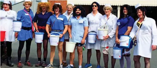  ??  ?? Light-hearted: Members of the charity on their annual dash dressed as female nurses to raise money for the local hospital